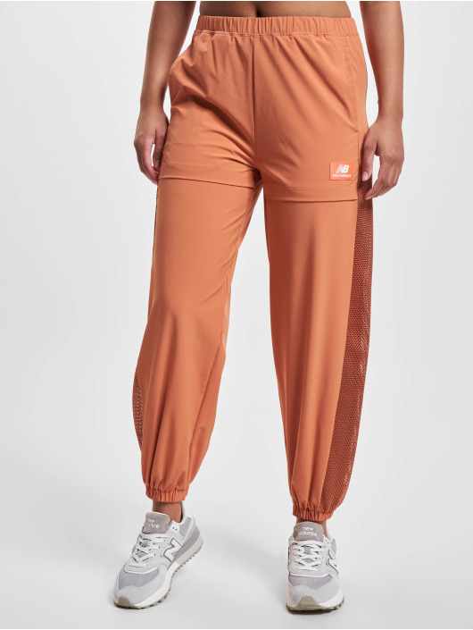 New Balance Látkové kalhoty All Terrain Hose oranžový