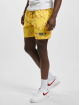 Karl Kani shorts Signature Smiley® Resort geel