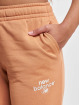New Balance Jogging kalhoty Essentials Graphic Fleece New hnědý