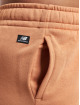 New Balance Jogging kalhoty Essentials Graphic Fleece New hnědý