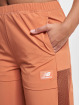 New Balance Látkové kalhoty All Terrain Hose oranžový
